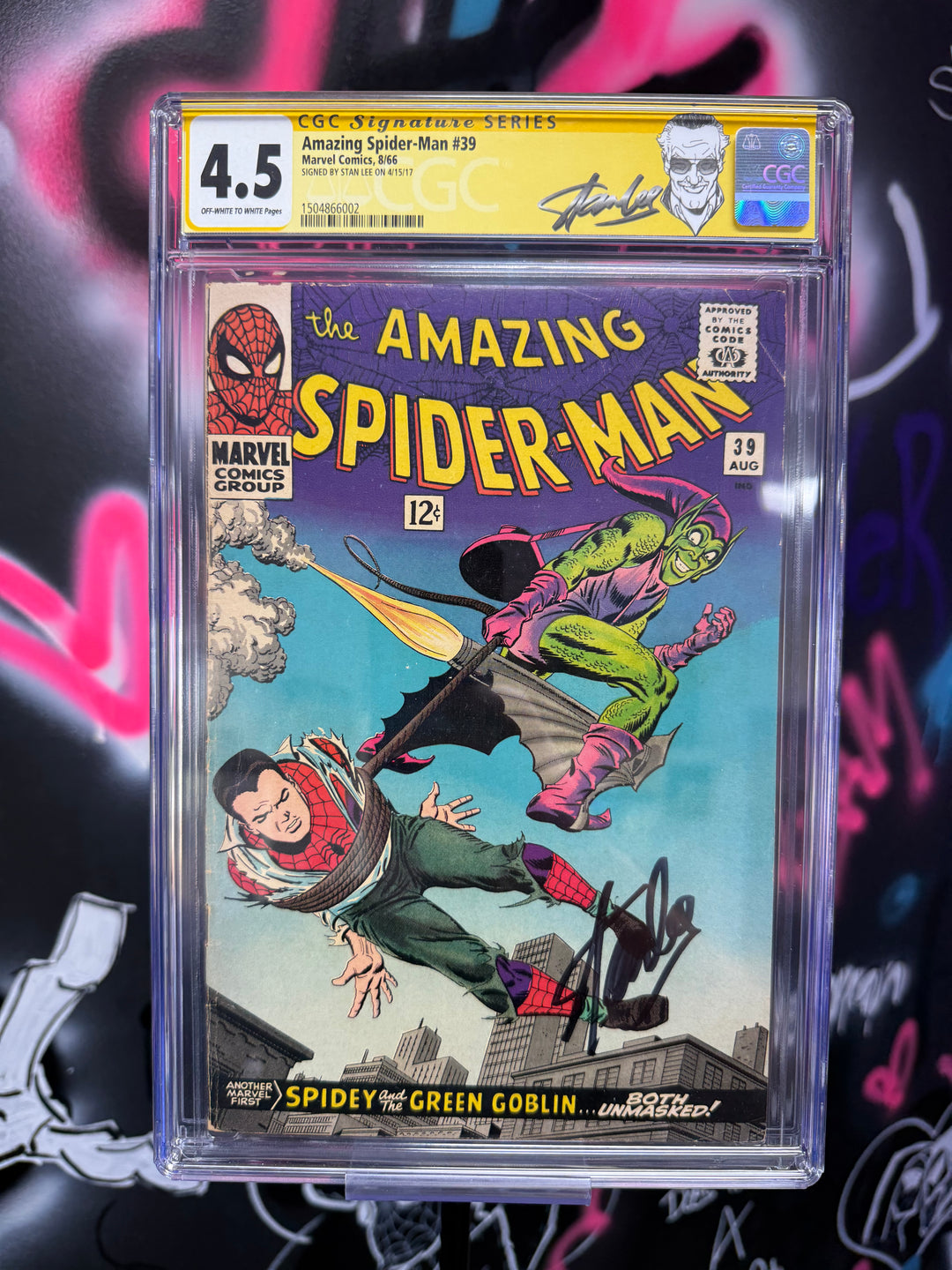 Comic book 'The Amazing Spider-Man' in a clear plastic case with grading label on a colorful background