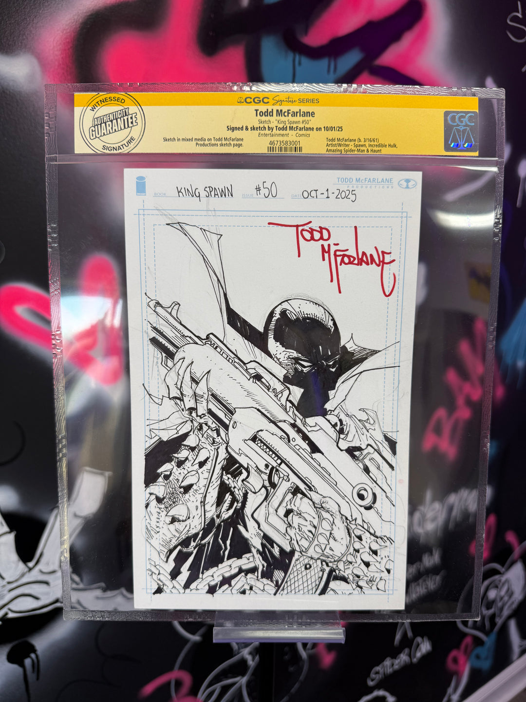 Comic book page with black and white illustration and red text, held in clear plastic.