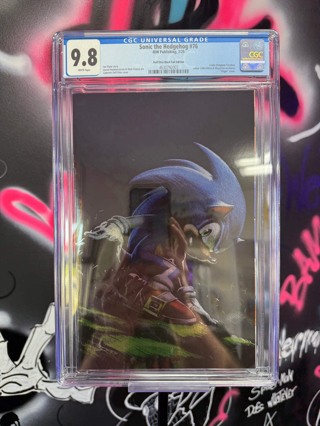 Comic book in clear plastic casing with CGC grading label against a graffiti-covered wall.